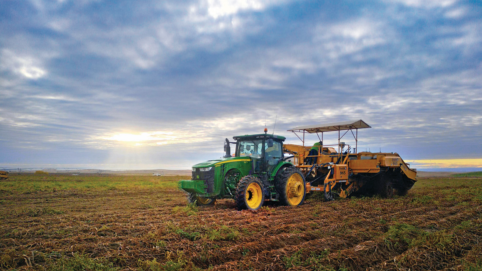 John Deere equipment plowing a field